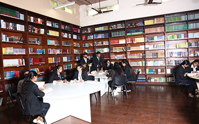 IMS Noida PGDM Students Studying in the Library A group of students studying in the IMS Noida library, focusing on academic activities.