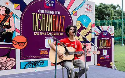 PGDM Student Performance at Tashanbaaz Event – Showcasing Talent and Passion A student performing a song at the Tashanbaaz event at IMS Noida, showcasing their talent on stage.